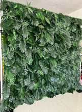 Charger l'image dans la galerie, Artificial tropical green leaf backdrop featuring a variety of realistic foliage. Perfect for event decoration, photo booths, and indoor or outdoor settings. How durable is this artificial greenery wall for extended outdoor use? Can the individual leaves or sections be rearranged for custom designs?