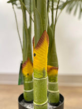 Charger l'image dans la galerie, Close-up of a palm tree's artificial trunk, displaying green stems with yellow and brown accents at the base. The detail highlights the textured and realistic design of the tree.