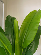 Load image into Gallery viewer, Close-up of large, vibrant green artificial banana leaves with realistic texture, enhancing indoor tropical decor
