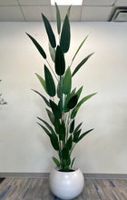 Load image into Gallery viewer, Tall artificial plant with dark green leaves in a round white pot placed against a plain white wall in an office setting