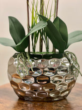 Charger l'image dans la galerie, Close-up of a shiny silver planter holding artificial orchid leaves and stems with detailed texture. Frequently asked question: What type of pots or planters are best for displaying artificial plants indoors?