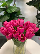Load image into Gallery viewer, A delicate bouquet of artificial red tulips displayed in a clear glass vase, set against a lush green background. How do I choose the right vase for displaying artificial flowers?