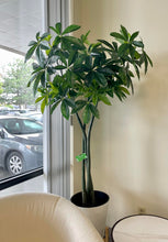 Charger l'image dans la galerie, Artificial money tree with lush green leaves in a stylish white textured planter, placed beside a cozy white armchair in a modern indoor setting, perfect for enhancing office or home decor