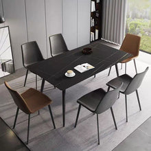 Charger l'image dans la galerie, What are the best black dining tables for a modern home? This minimalist dining room features a sleek black dining table with slim legs, surrounded by a mix of black and brown leather chairs. The simple yet sophisticated design creates a contemporary look, perfect for modern interiors with a neutral color palette.