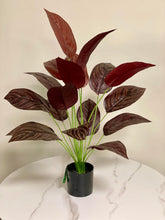 Load image into Gallery viewer, Elegant artificial dark red tropical plant with broad, textured leaves, perfect for adding a touch of sophistication to indoor spaces.