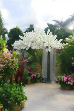 Load image into Gallery viewer, rtificial cherry blossom tree in pure white, available for rental. This stunning centerpiece is perfect for enhancing weddings, corporate events, and sophisticated settings with its realistic blossoms and sturdy design. Ideal for adding a touch of serenity and beauty to any event decor