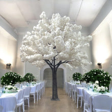 Charger l'image dans la galerie, Elegant white artificial cherry blossom tree standing tall in a beautifully decorated wedding venue with white and pastel floral arrangements. Perfect for enhancing wedding or event decor with a touch of sophistication and nature. How durable are artificial trees for repeated use?