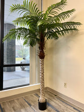 Charger l'image dans la galerie, A large artificial palm tree in a stylish office corner by the window, adding a natural touch to a professional setting.