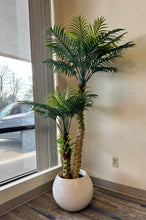 Load image into Gallery viewer, Artificial palm tree in a stylish white planter pot, ideal for enhancing modern living rooms or office environments.