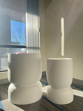 Charger l'image dans la galerie, Set of two white stackable planters with a smooth matte finish, displayed empty indoors near a window with natural sunlight. Are these planters suitable for both indoor and outdoor use?