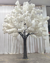 Charger l'image dans la galerie, A tall artificial white blossom tree with a sturdy base, displayed against a plain white backdrop. Suitable for indoor event decor and photo backdrops. How durable are the materials used for these artificial trees?
