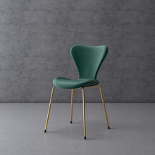 Charger l'image dans la galerie, Contemporary green chair with gold legs, set against a minimalistic grey background. Frequently asked questions include 'What are the most comfortable chair designs for dining rooms?' and 'How do you maintain velvet upholstery on modern chairs?
