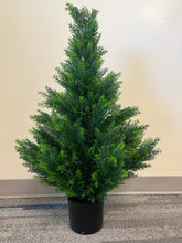 Charger l'image dans la galerie, Artificial small evergreen tree in a black pot, featuring dense, lush green foliage, ideal for adding a touch of greenery to indoor spaces.