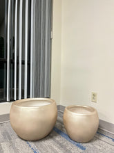 Charger l'image dans la galerie, gold cement round planters with a smooth finish, placed indoors on a carpeted floor near a window. What are the dimensions and weight of these planters?