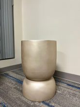 Charger l'image dans la galerie, Gold stackable planter with a smooth metallic finish, displayed empty indoors on a carpeted floor near a window. Is this planter suitable for modern minimalist decor?