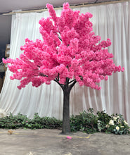 Load image into Gallery viewer, A stunning artificial pink cherry blossom tree with dense, vibrant flowers set against a white curtain backdrop, perfect for indoor decorations or events. Is this tree weatherproof for outdoor use?