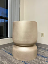 Charger l'image dans la galerie, Gold stackable planter with a smooth metallic finish, displayed empty indoors on a carpeted floor near a window. Is this planter suitable for modern minimalist decor?