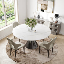 Load image into Gallery viewer, dining room featuring round white tulip table with black pedestal base, cream tufted dining chairs, large round beige shag area rug, abstract framed wall art in gold frame, decorative ceramic vases and sculptures, built-in speaker cabinet sideboard, fresh floral arrangement centerpiece on table, windows overlooking lush outdoor scenery.