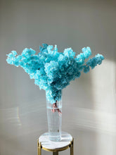 Load image into Gallery viewer, Delicate light blue artificial flowers arranged in a tall, clear glass vase filled with water, sitting gracefully on a marble and gold pedestal. Perfect for weddings, events, and sophisticated home décor. Looking for timeless floral elegance for your next event?