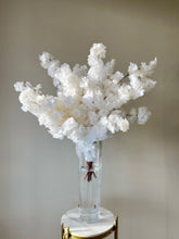 Load image into Gallery viewer, Elegant arrangement of artificial white cherry blossom flowers in a tall clear glass vase placed on a marble pedestal. How can this floral display enhance indoor event decorations?