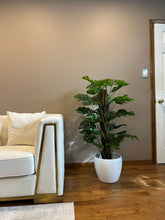 Charger l'image dans la galerie, Artificial Monstera plant in a white pot placed next to a modern white couch. How can I use artificial plants to enhance living room décor?