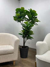 Load image into Gallery viewer, This fiddle-leaf fig tree in a sleek white pot adds a fresh and modern touch to the space, perfectly balancing the minimalistic decor with its vibrant greenery.