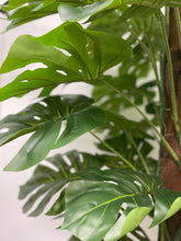 Charger l'image dans la galerie, Close-up of a green tag labeled 'Waysaving' attached to the stem of an artificial monstera plant, showcasing the detailed texture of the plant’s stem and leaves, as well as the brown support pole.