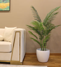 Charger l'image dans la galerie, artificial palm tree. Artificial palm tree in a white planter, positioned beside a modern beige couch in a cozy living room.