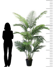 Charger l'image dans la galerie, Tall artificial palm tree with lush green leaves, displayed next to a silhouette for scale, showing its impressive height and fullness.
