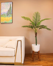 Charger l'image dans la galerie, Stylish artificial palm tree in a modern white planter, enhancing the aesthetic of a cozy living room.