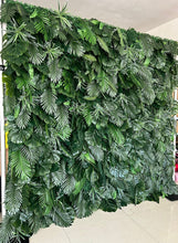 Charger l&#39;image dans la galerie, Artificial tropical green leaf backdrop featuring a variety of realistic foliage. Perfect for event decoration, photo booths, and indoor or outdoor settings. How durable is this artificial greenery wall for extended outdoor use? Can the individual leaves or sections be rearranged for custom designs?
