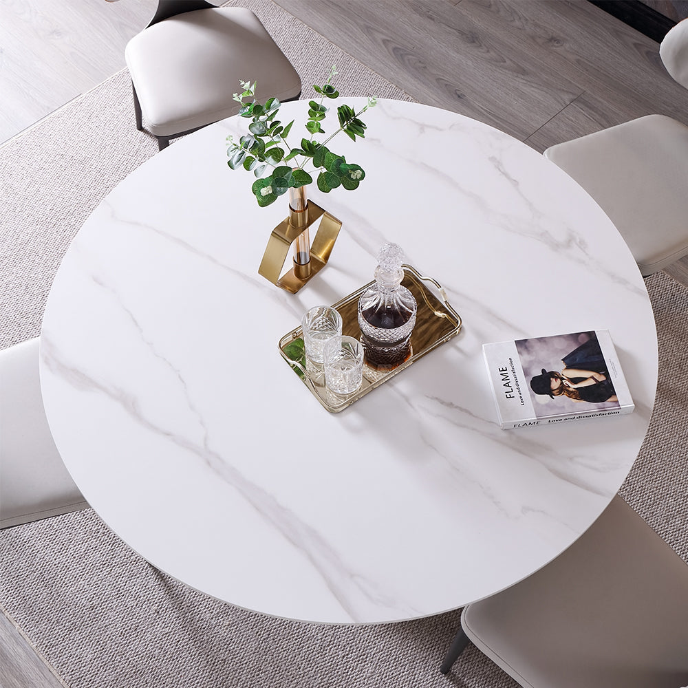 Alt text: A stylish modern living room featuring a round marble coffee table with decorative vases complemented by gray armchair, creating an inviting and chic atmosphere.