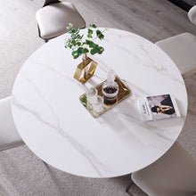 Charger l&#39;image dans la galerie, Alt text: A stylish modern living room featuring a round marble coffee table with decorative vases complemented by gray armchair, creating an inviting and chic atmosphere.
