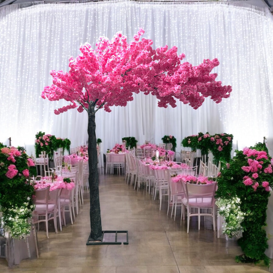 Elegant artificial cherry blossom tree with pink flowers, perfectly placed amidst a lavishly decorated wedding venue featuring pink floral arrangements and cascading fairy lights. Can this artificial tree be customized to match different event themes?