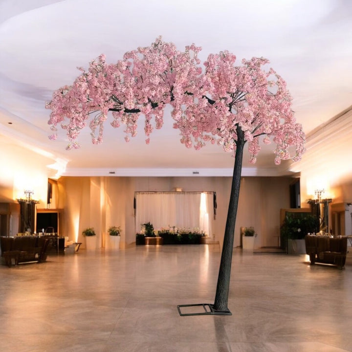 Artificial cherry blossom tree in a large indoor space with a high ceiling.