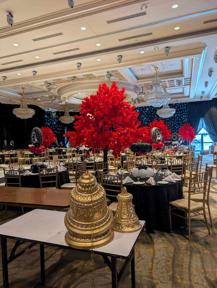 Decorative setup with gold towers and red cherry blossom floral arrangements in a  GTA event.
