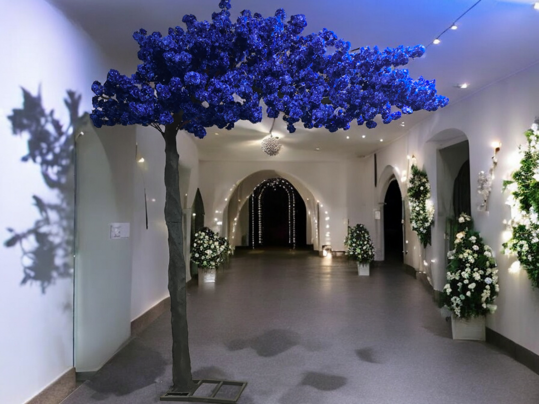 A striking dark blue artificial cherry blossom arch tree with cascading blossoms is showcased in an elegant indoor venue in Toronto and GTA events.