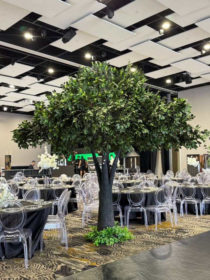 Large artificial ficus tree arranged in a GTA event space with other décor pieces in the background