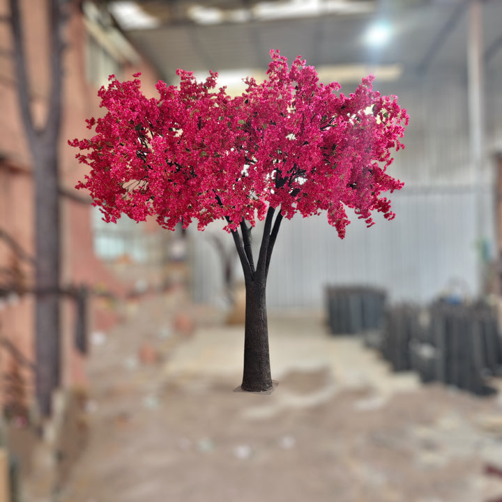 Vivid artificial bougainvillea tree with vibrant red blossoms set in a workshop in Mississauga.
