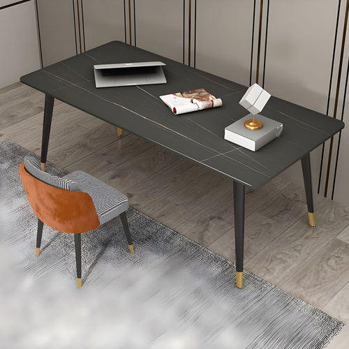 What are the best modern desks for a stylish home office? This sleek black desk with gold accents offers a spacious surface, ideal for a minimalist workspace. Paired with a contemporary chair featuring a mix of houndstooth and orange velvet upholstery, the setup creates a chic and functional office environment.