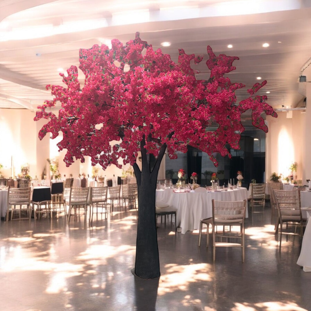 Decorative hot pink bougainvillea tree in a large indoor space with tables and chairs.