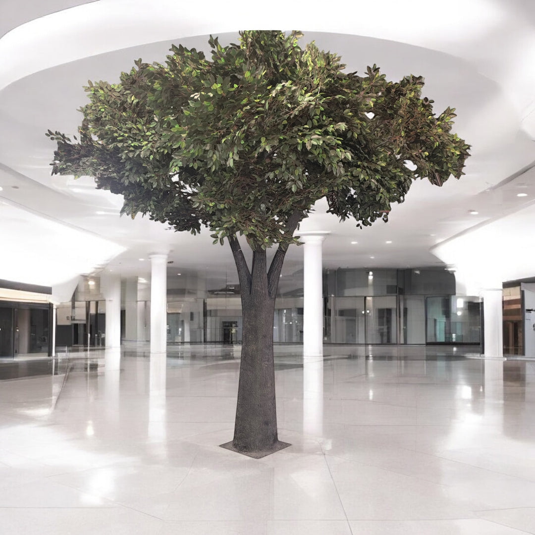 Large artificial tree in a modern indoor setting with white floor and ceiling