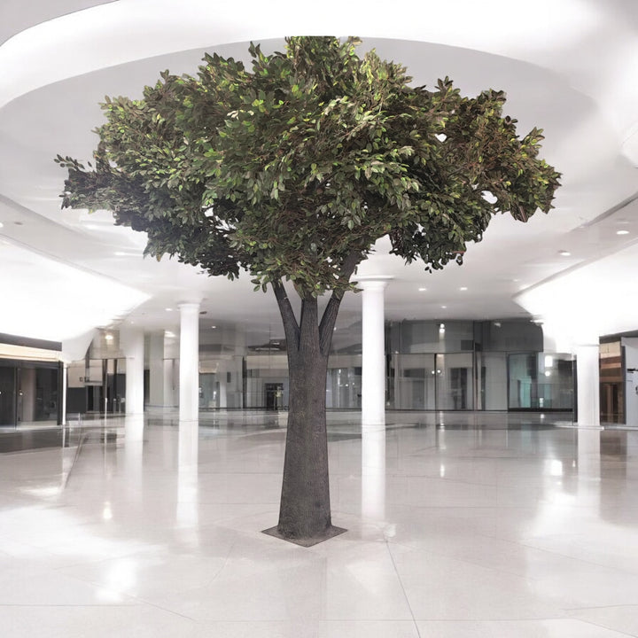 Large artificial tree in a modern indoor setting with white floor and ceiling