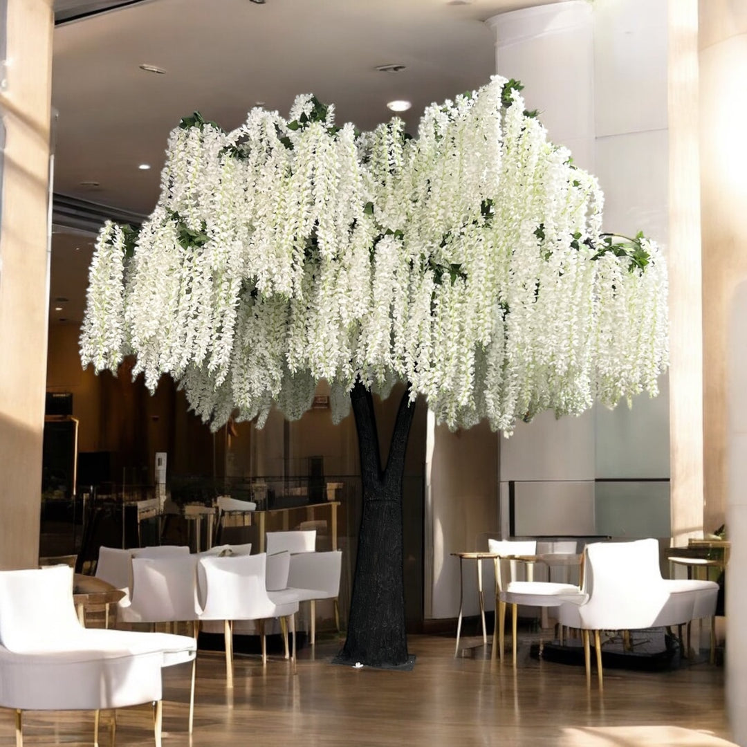 Decorative white wisteria floral arrangement in a modern indoor setting with chairs and tables.