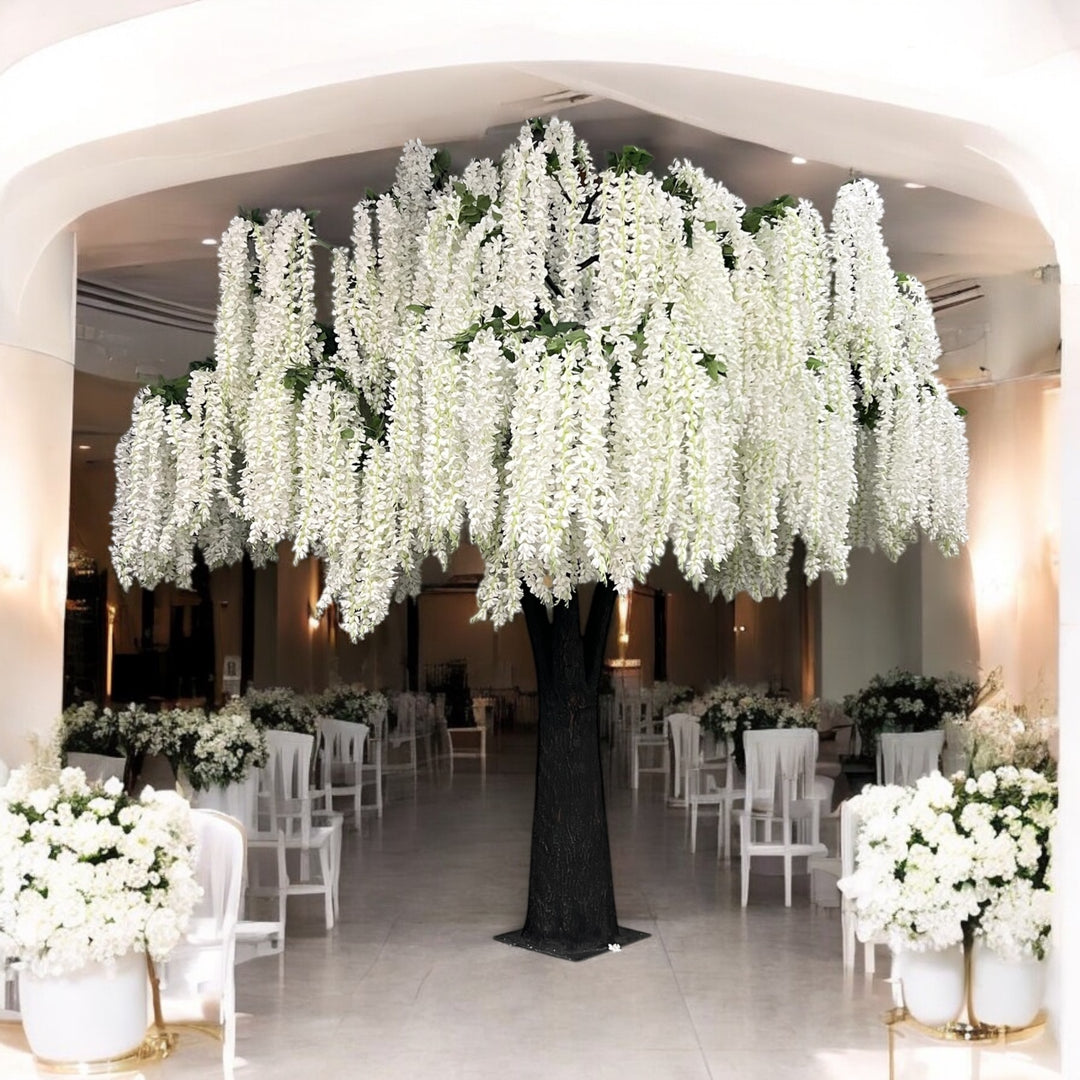 Decorative white wisteria floral arrangement with white flowers in a large indoor setting.