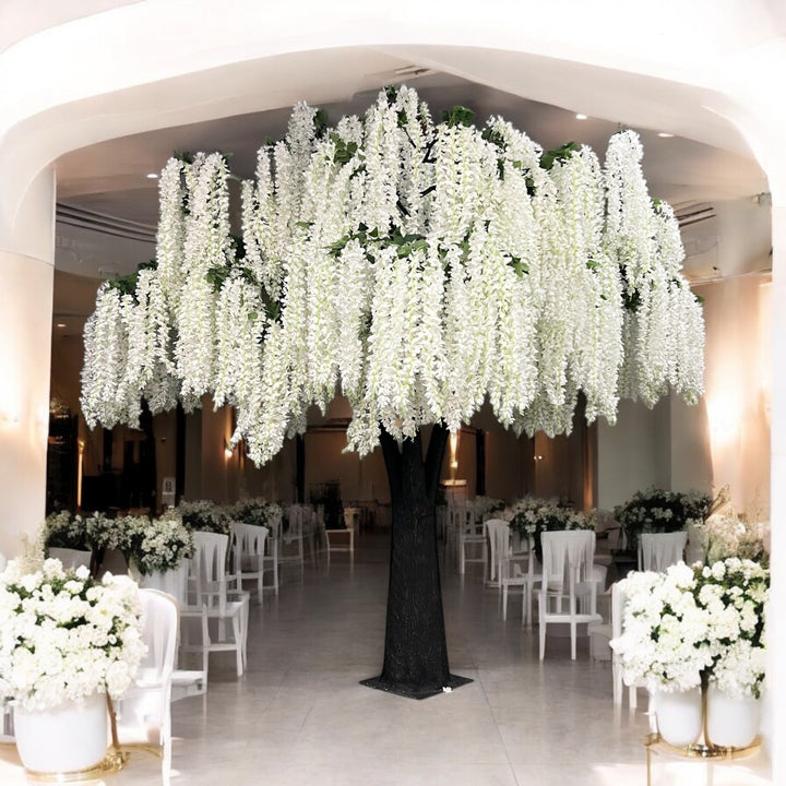 Decorative white wisteria floral arrangement with white flowers in a large indoor setting.