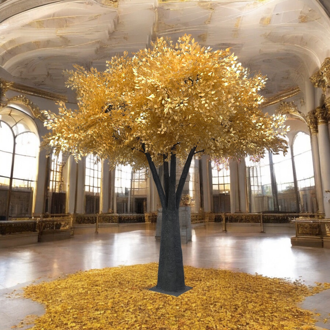 Large decorative ficus tree with gold leaves in a grand room with high ceilings and large windows.