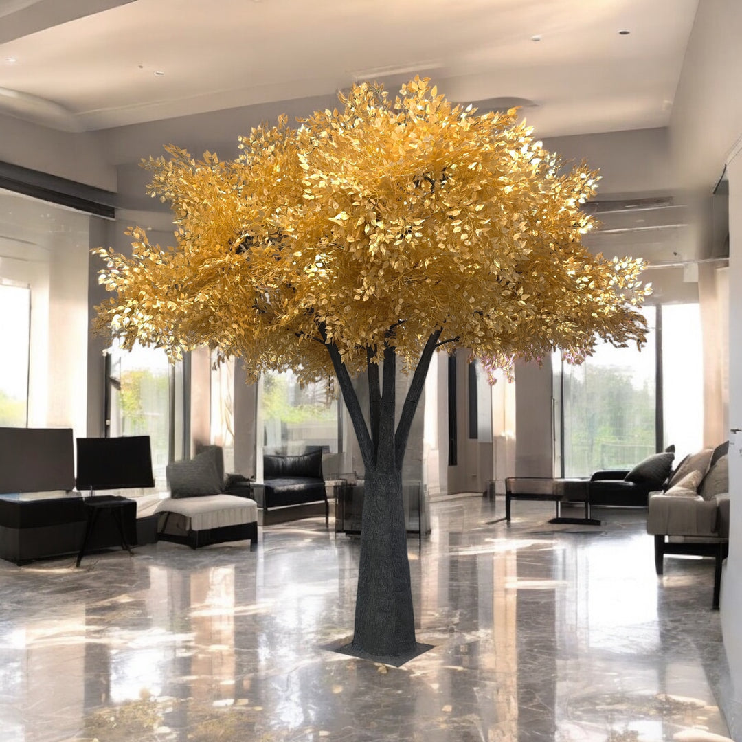 Decorative indoor tree with gold leaves  ficus in a modern room.