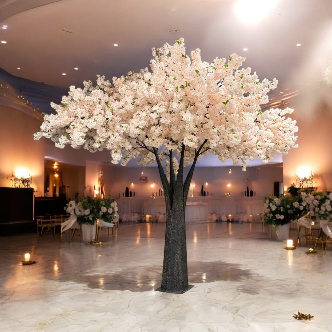 Decorative artificial 15ft  pink white cherry blossom tree in a large indoor space with tables and chairs.