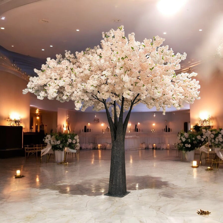 Decorative artificial 15ft  pink white cherry blossom tree in a large indoor space with tables and chairs.